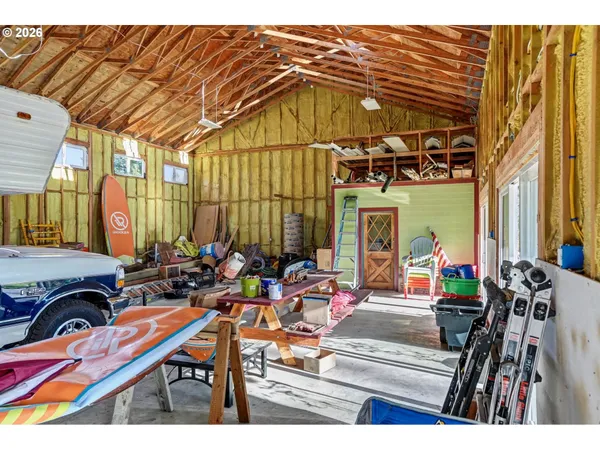 a view of a patio with a table and chairs under an umbrella