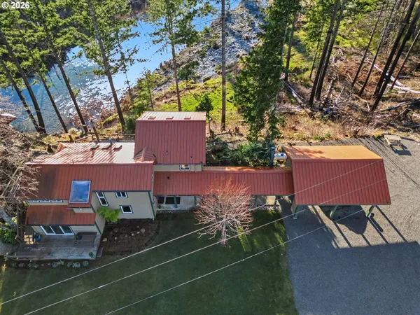 an aerial view of a house with a yard