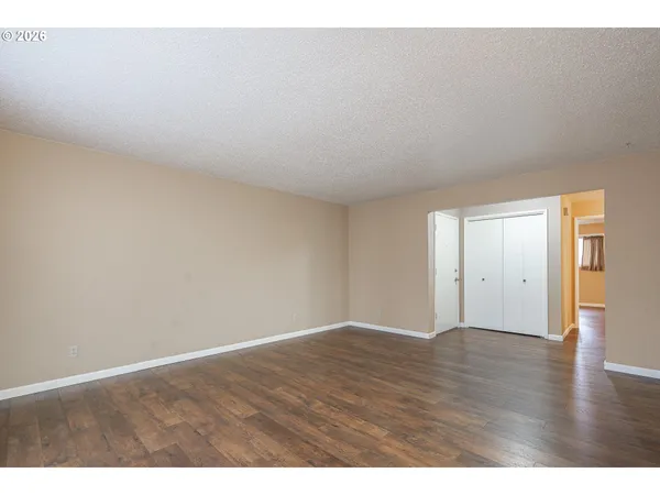 a view of an empty room and wooden floor
