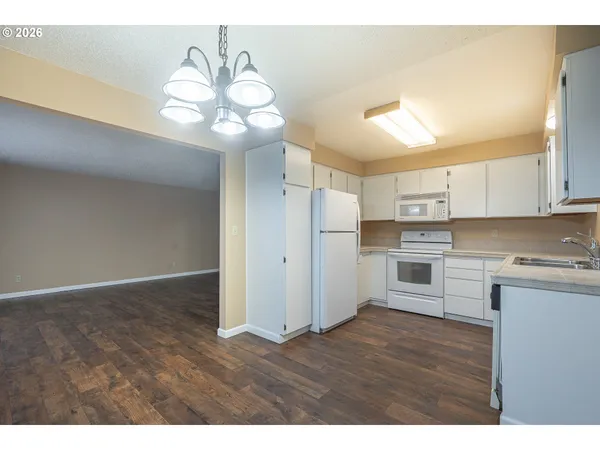 a view of a kitchen with wooden floor