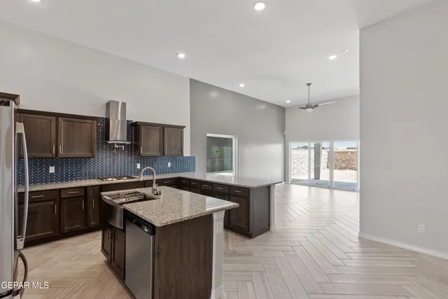 a kitchen with a sink stove and refrigerator