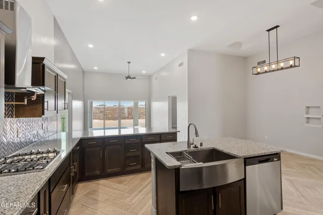a kitchen with a sink a counter and cabinets