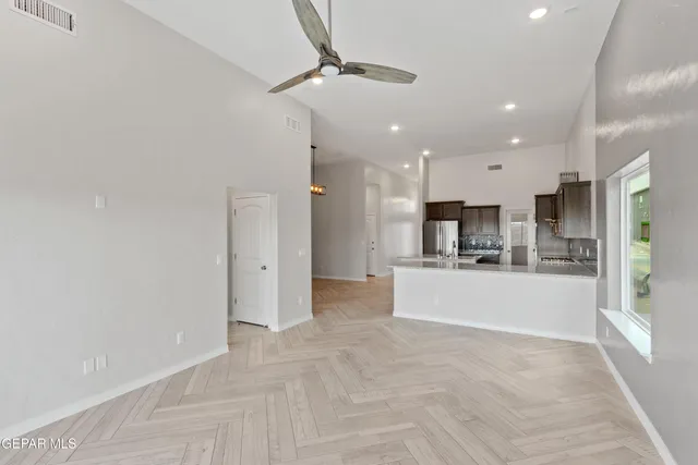 a view of kitchen with refrigerator and window