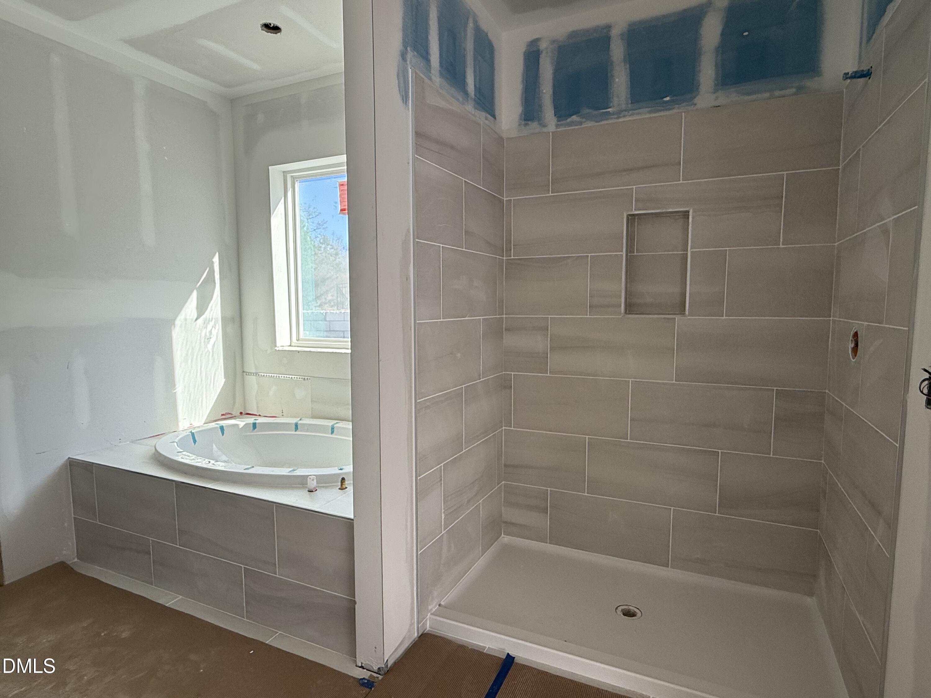 2205 Seraphic Way, Unit 403 Rolesville, NC 27571 - Photo 13 of 41 a bathroom with a bathtub and a sink