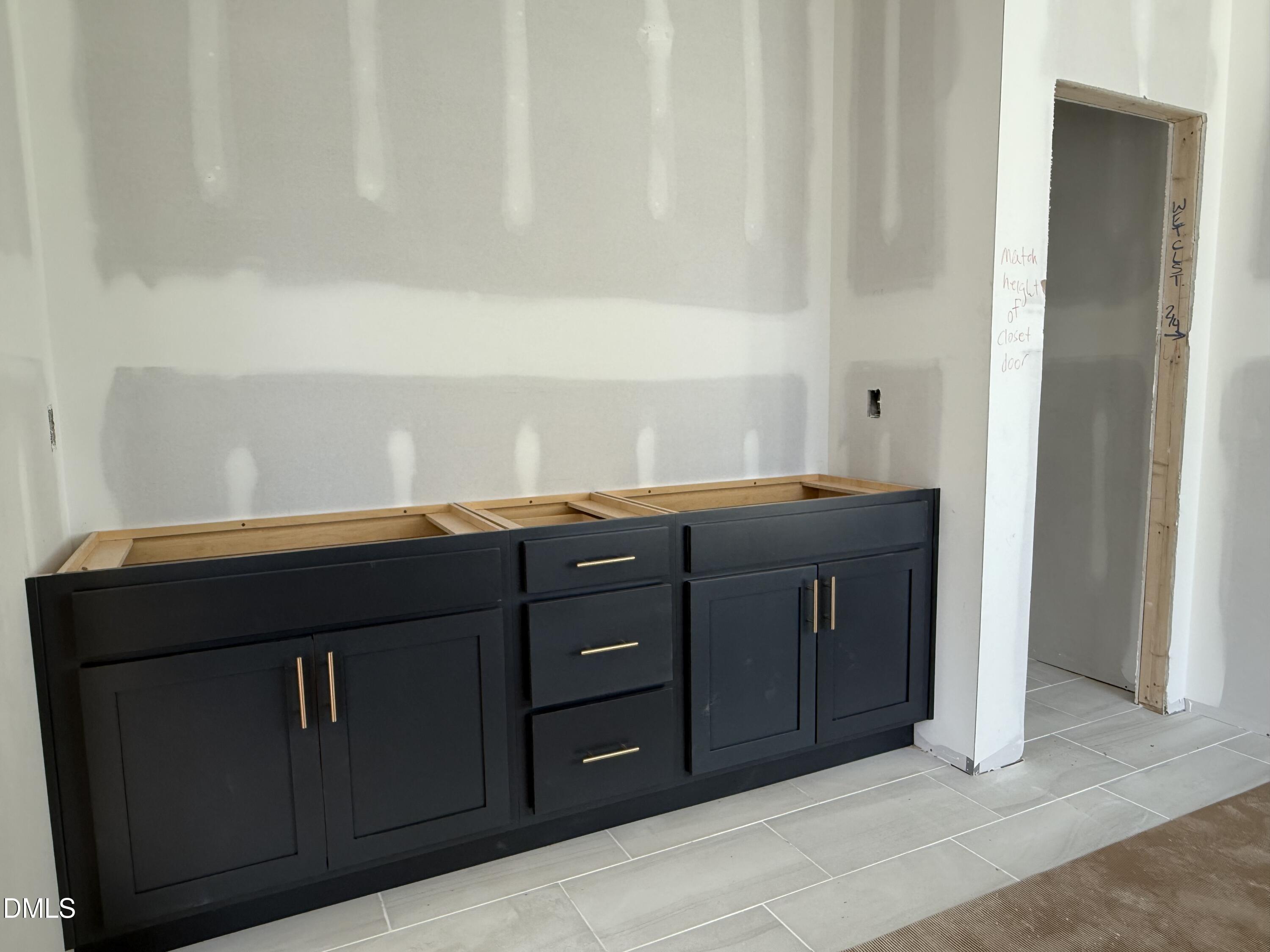 2205 Seraphic Way, Unit 403 Rolesville, NC 27571 - Photo 14 of 41 a kitchen with a sink and cabinets