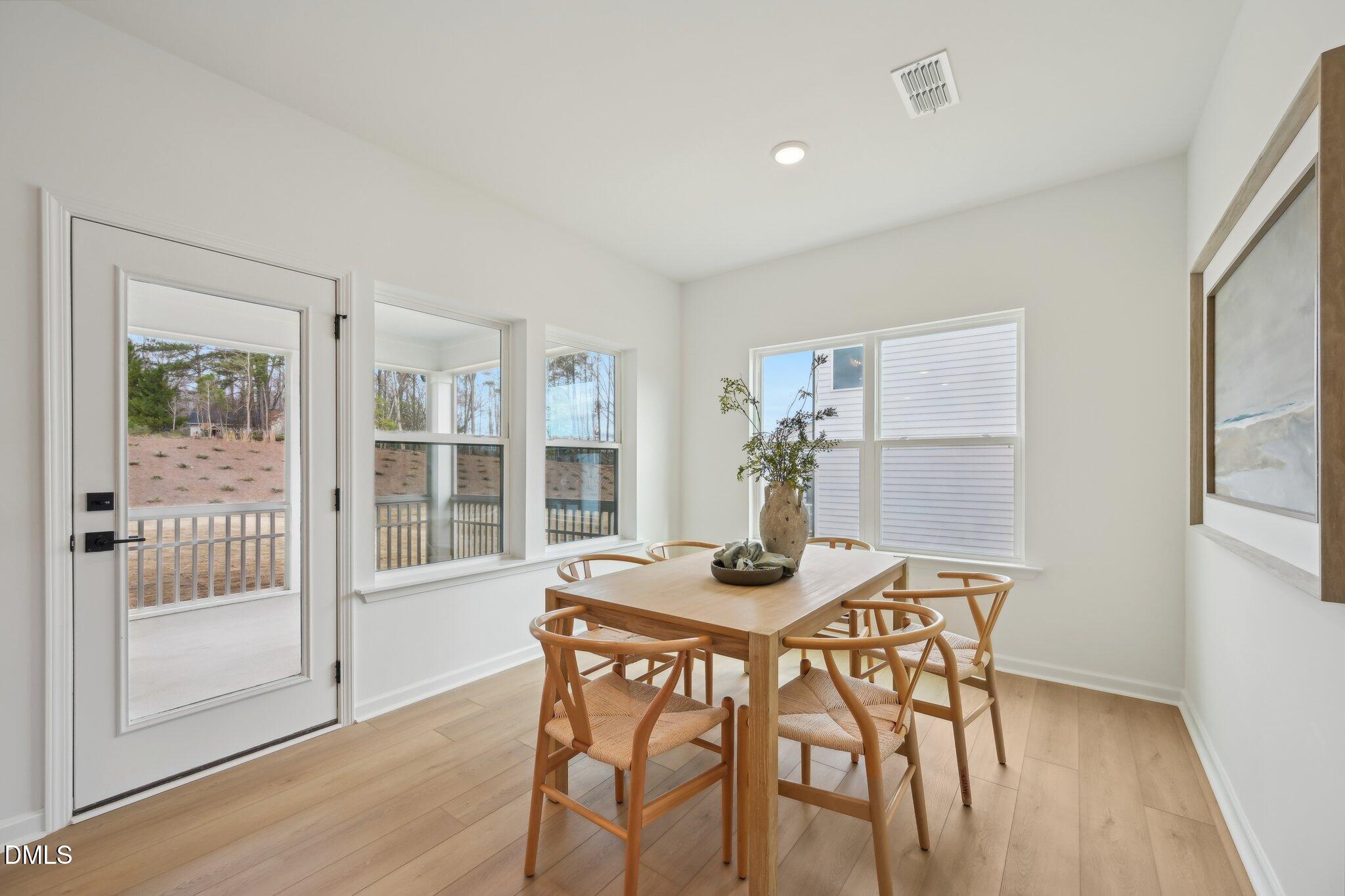 2205 Seraphic Way, Unit 403 Rolesville, NC 27571 - Photo 28 of 41 a view of a dining room with furniture and wooden floor