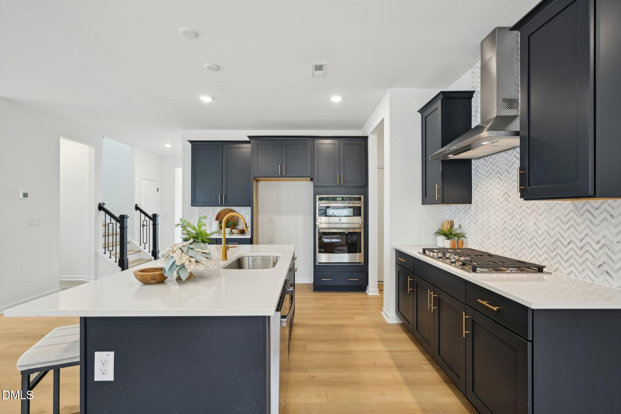 2205 Seraphic Way, Unit 403 Rolesville, NC 27571 - Photo 29 of 41 a kitchen with stainless steel appliances a sink stove and refrigerator