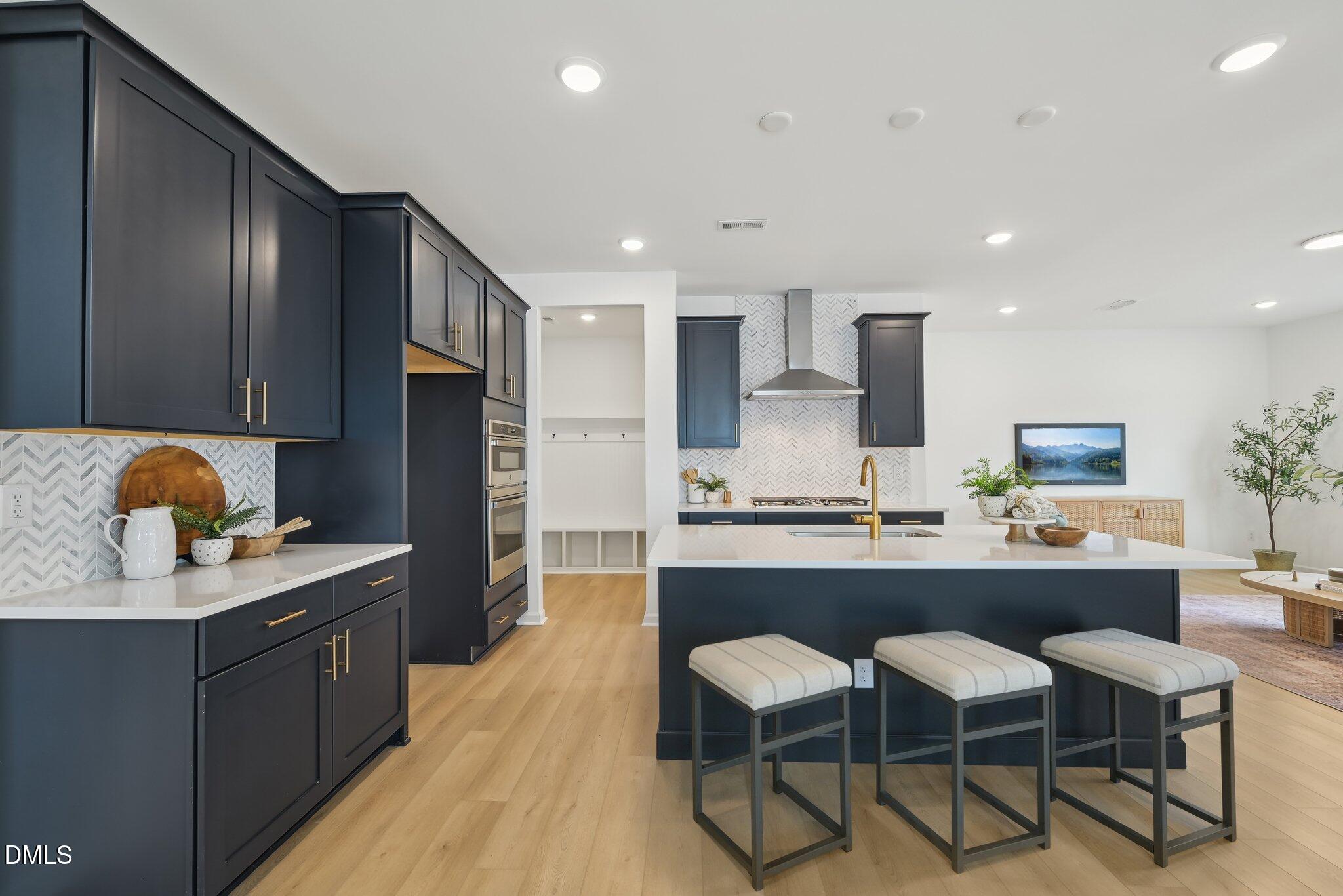 2205 Seraphic Way, Unit 403 Rolesville, NC 27571 - Photo 30 of 41 a kitchen with stainless steel appliances kitchen island granite countertop a sink and cabinets