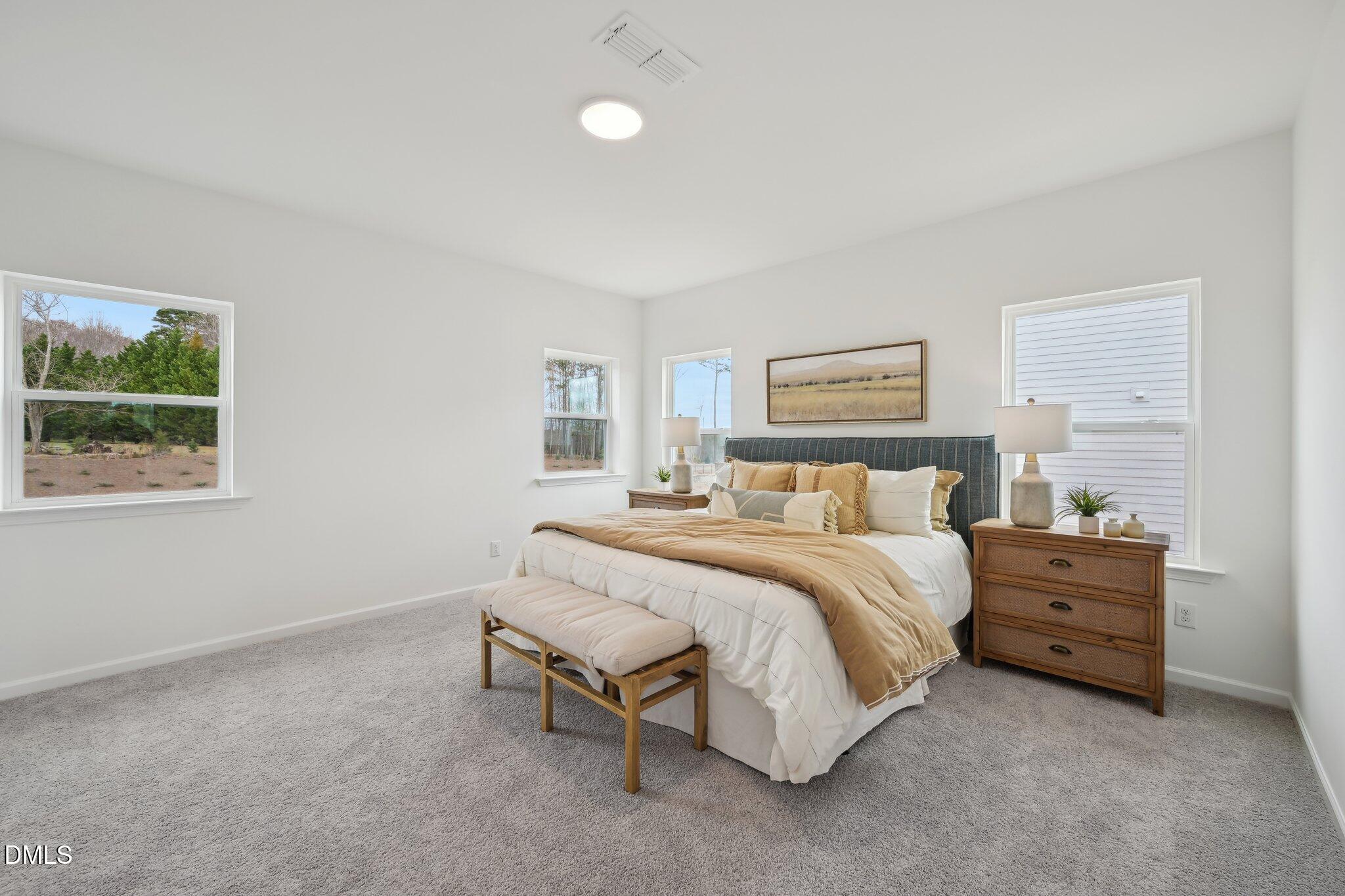 2205 Seraphic Way, Unit 403 Rolesville, NC 27571 - Photo 36 of 41 a spacious bedroom with a bed and a window