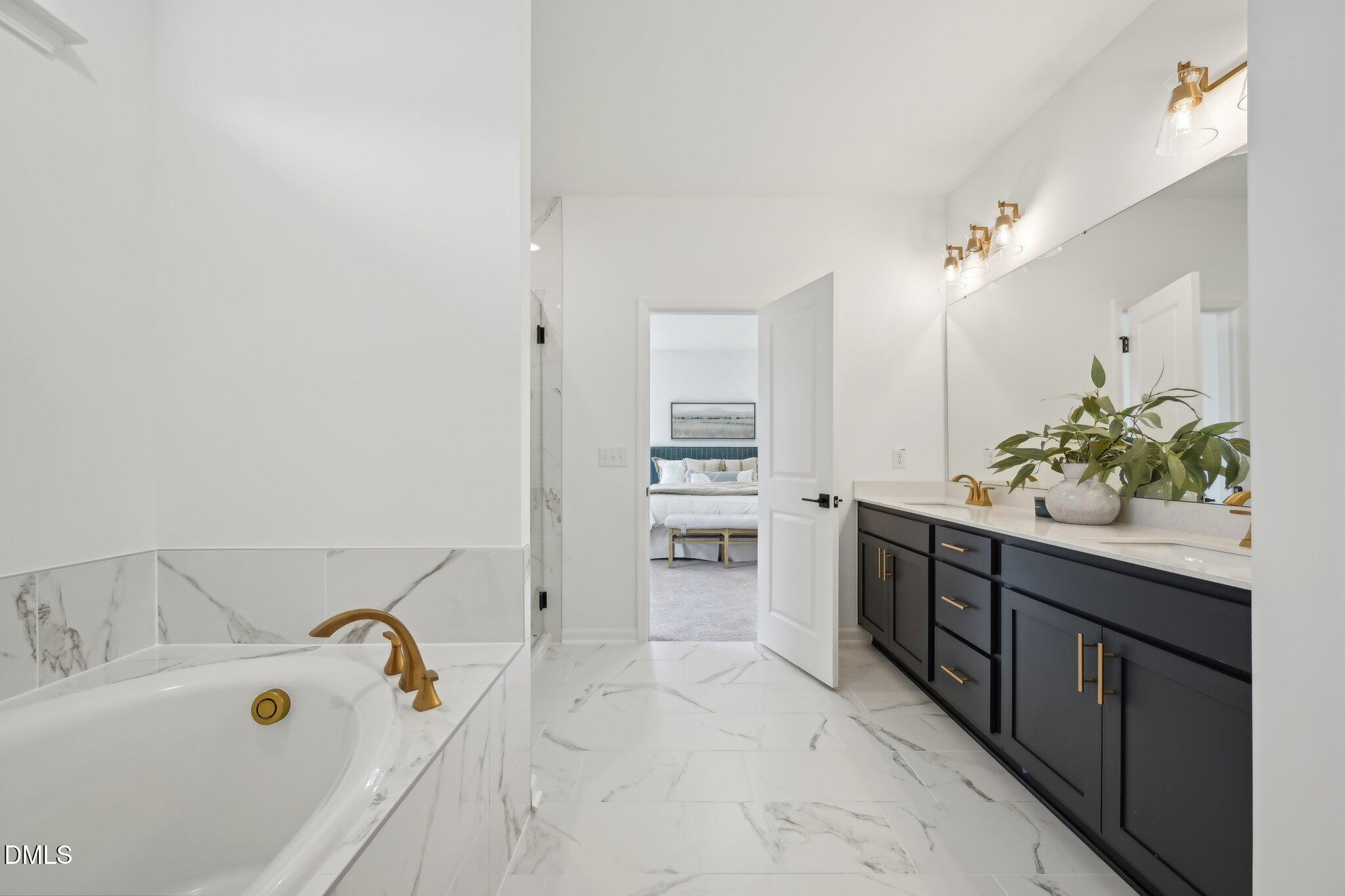 2205 Seraphic Way, Unit 403 Rolesville, NC 27571 - Photo 37 of 41 a bathroom with a tub sink and mirror