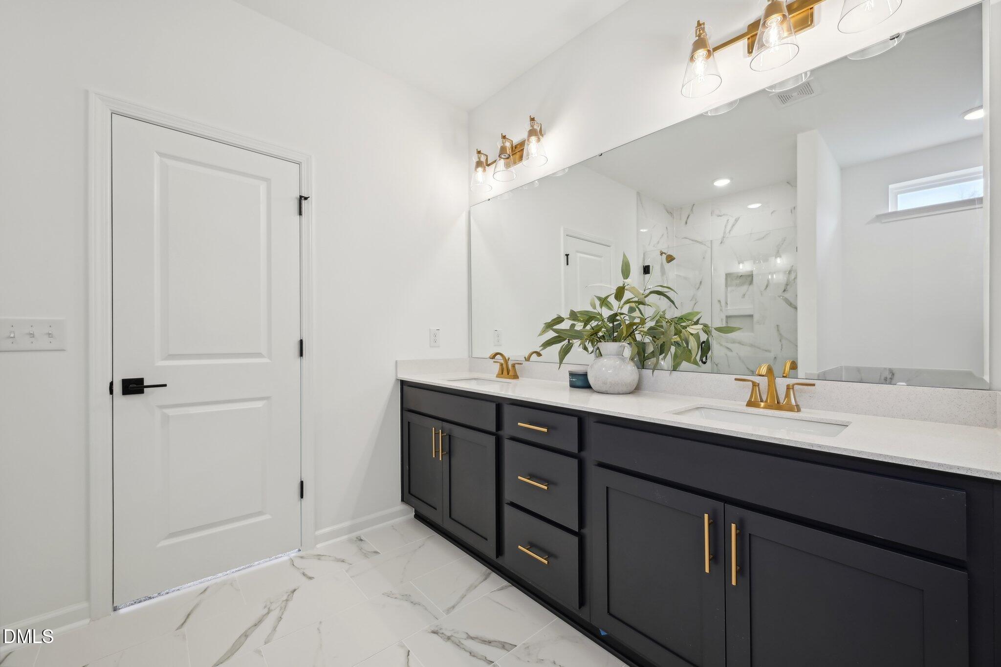 2205 Seraphic Way, Unit 403 Rolesville, NC 27571 - Photo 38 of 41 a bathroom with a sink and a mirror