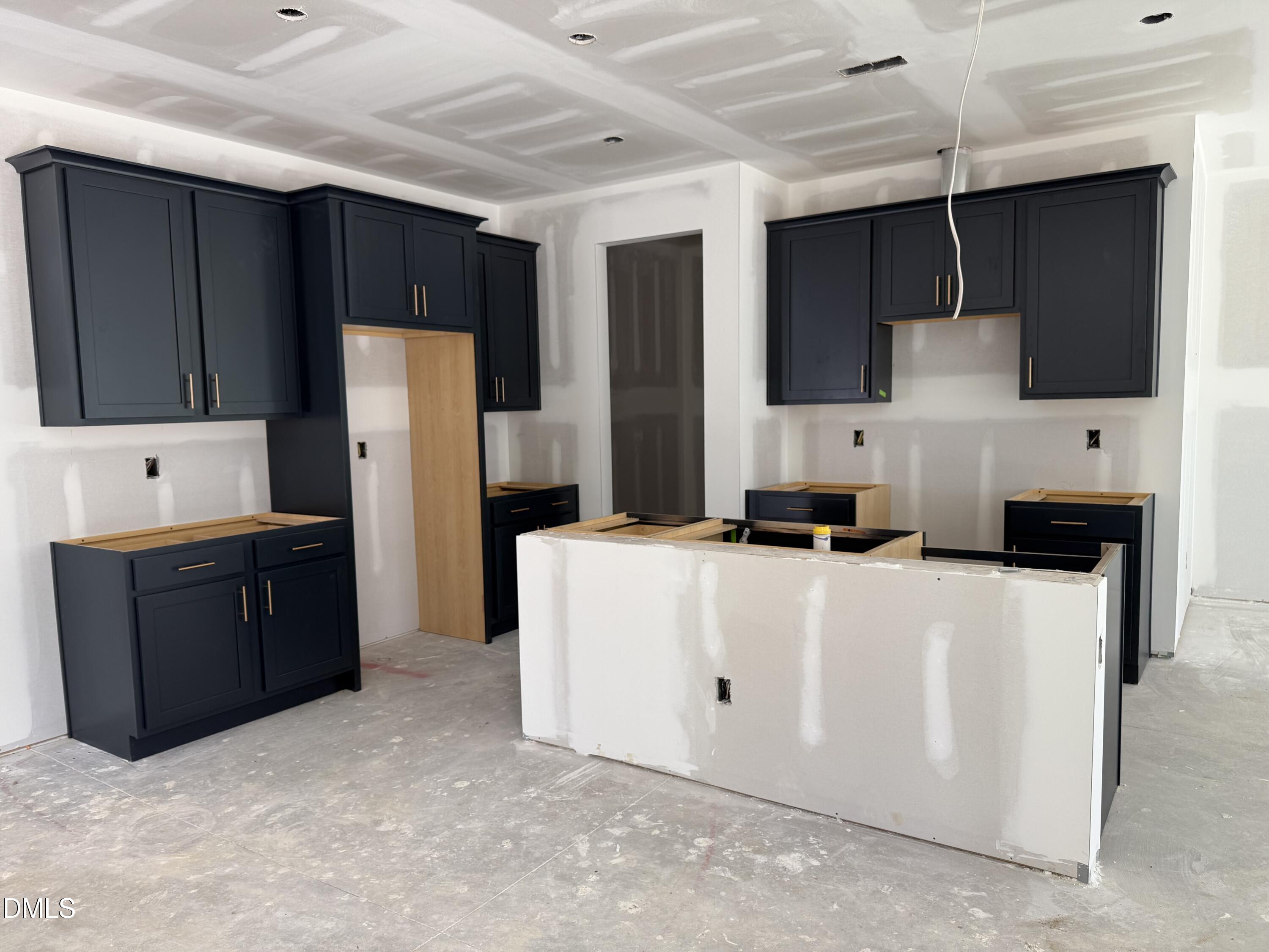 2205 Seraphic Way, Unit 403 Rolesville, NC 27571 - Photo 5 of 41 a room with a cabinets and a flat screen tv