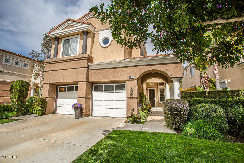 11249 Shadyridge Road Moorpark, CA 93021 - Photo 2 of 48 a front view of a house with a yard and garage