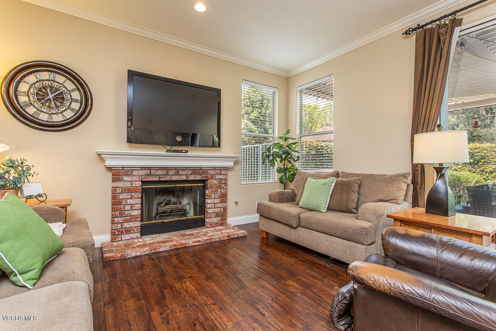 11249 Shadyridge Road Moorpark, CA 93021 - Photo 14 of 48 a living room with furniture a flat screen tv and a fireplace
