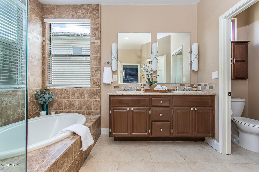 11249 Shadyridge Road Moorpark, CA 93021 - Photo 25 of 48 a spacious bathroom with a tub double sink and mirror