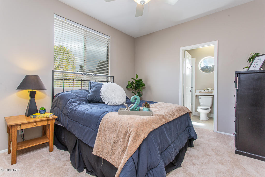 11249 Shadyridge Road Moorpark, CA 93021 - Photo 30 of 48 a bedroom with a bed and a chandelier