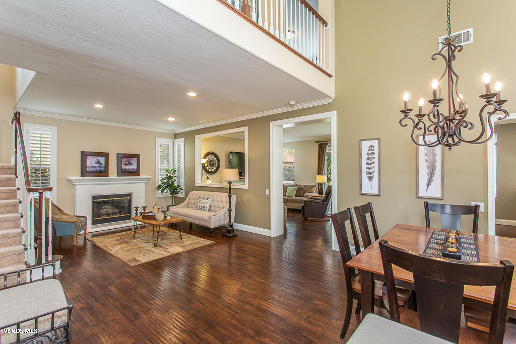 11249 Shadyridge Road Moorpark, CA 93021 - Photo 6 of 48 a living room with fireplace furniture and a wooden floor