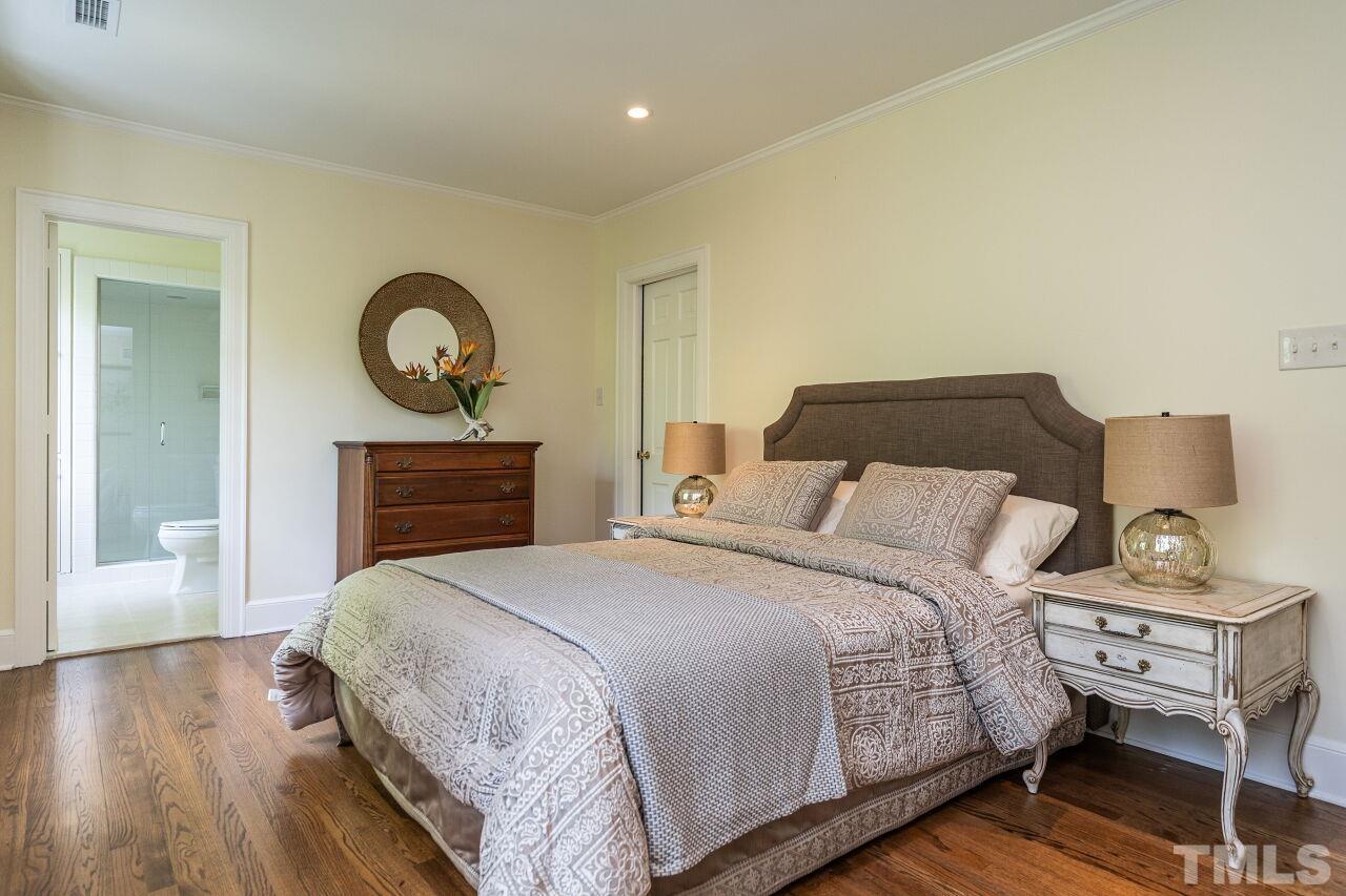 903 Wakestone Court Raleigh, NC 27609 - Photo 24 of 40 a bedroom with a bed and a lamp on dresser