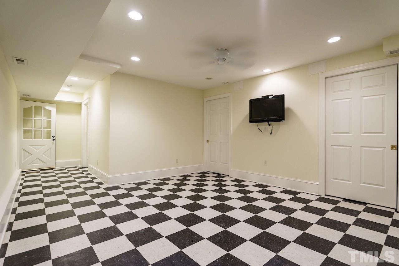 903 Wakestone Court Raleigh, NC 27609 - Photo 29 of 40 a living room with a black white checkered floor