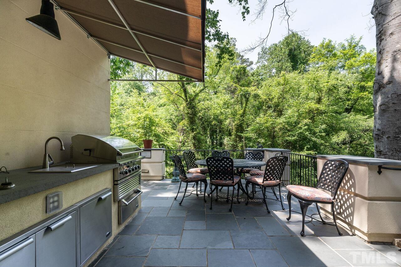 903 Wakestone Court Raleigh, NC 27609 - Photo 34 of 40 a view of a chairs and table in the back yard