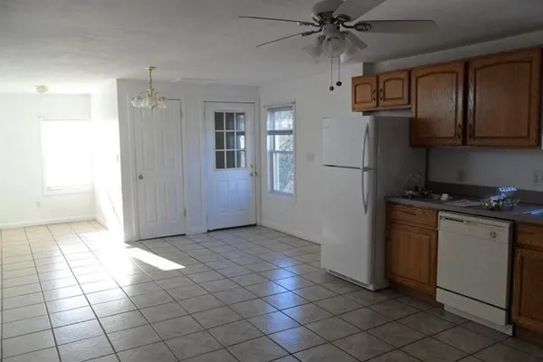 a kitchen with a stove a refrigerator and cabinets