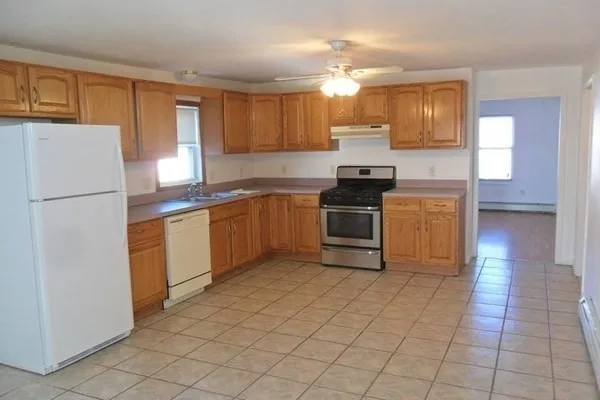 a kitchen with stainless steel appliances granite countertop a stove a sink and a refrigerator