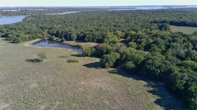an aerial view of a houses with a yard