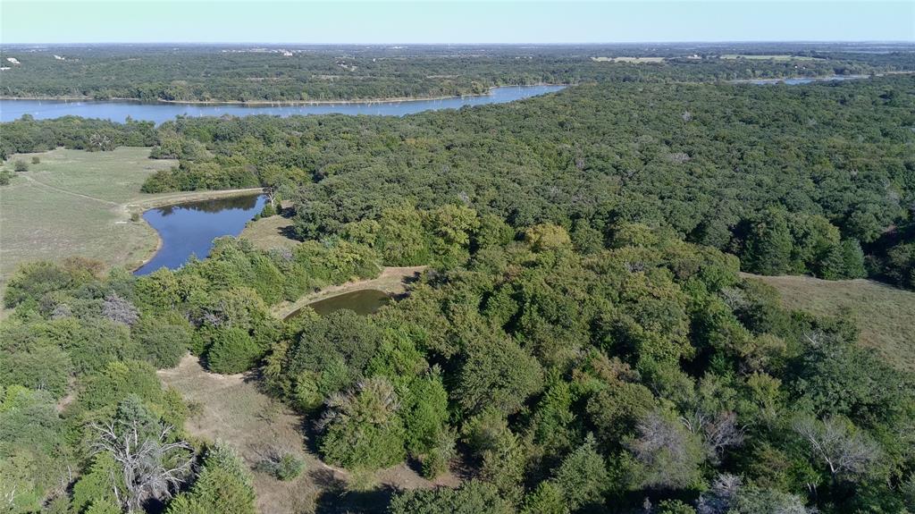 9190 East Fm 922 Valley View Valley View, TX 76272 - Photo 6 of 11 a view of a lush green field with a lake