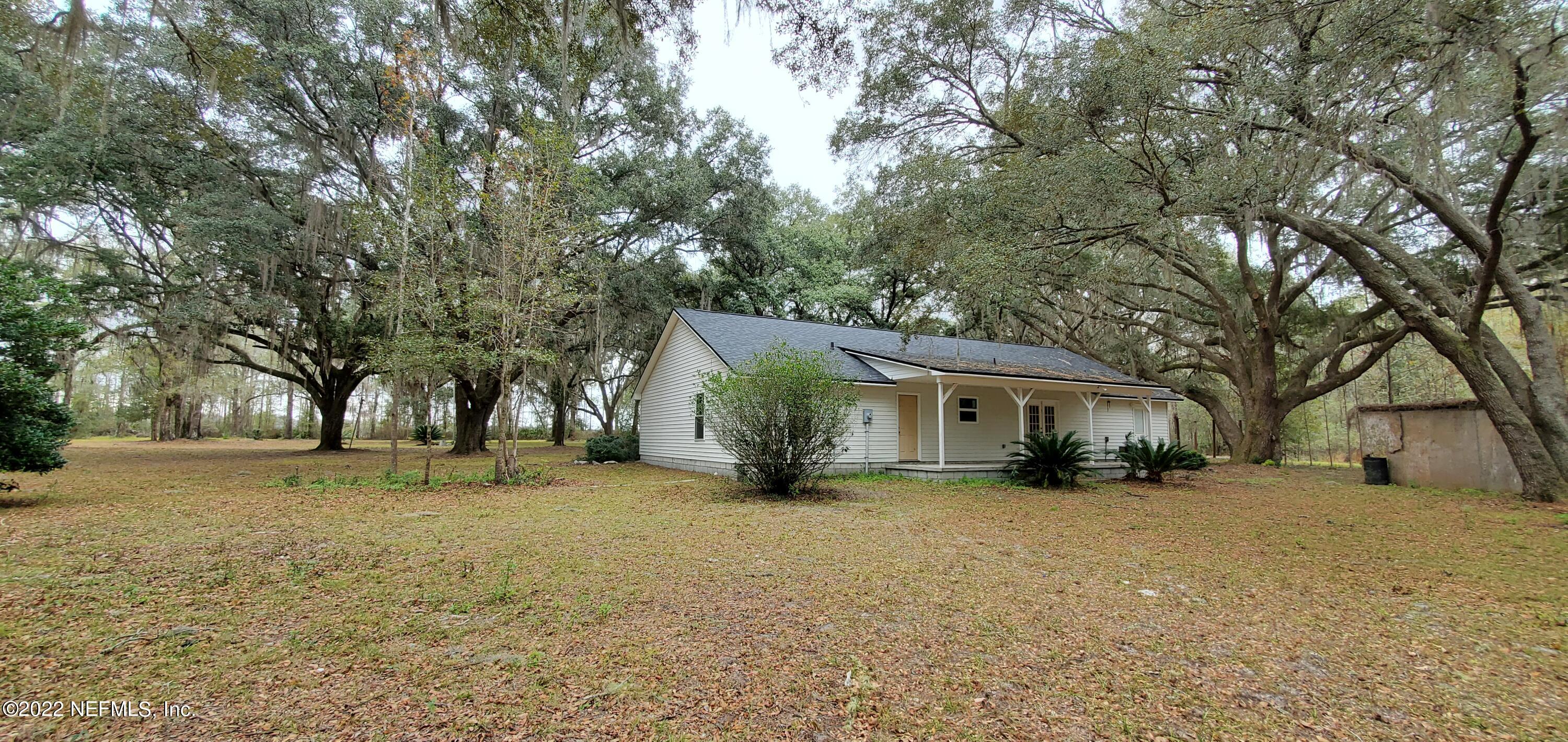 3578 Hamp Hicks Road Bryceville, FL 32009 - Photo 12 of 16 a view of a house with a yard covered with snow in front of house