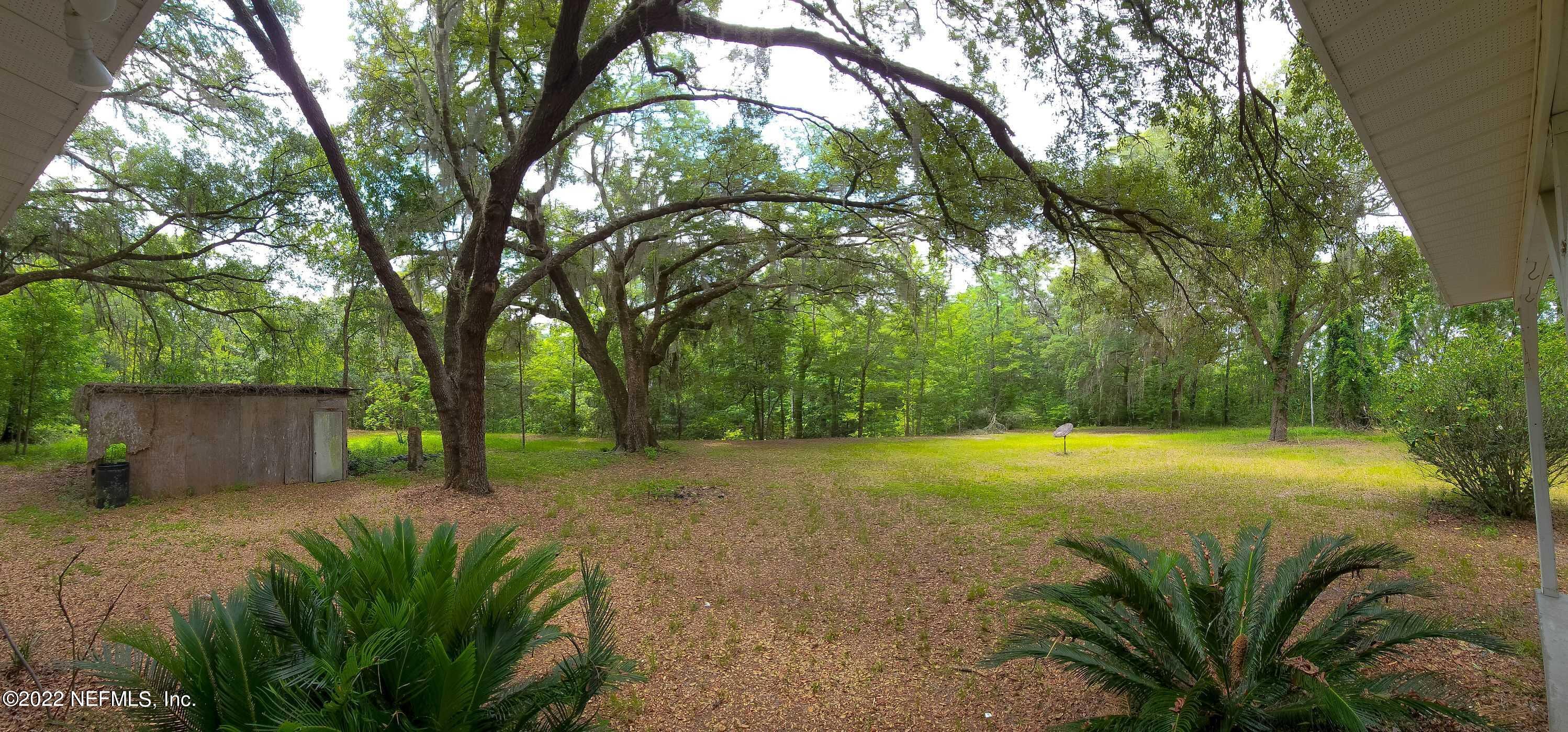 3578 Hamp Hicks Road Bryceville, FL 32009 - Photo 16 of 16 a view of a backyard with a trees