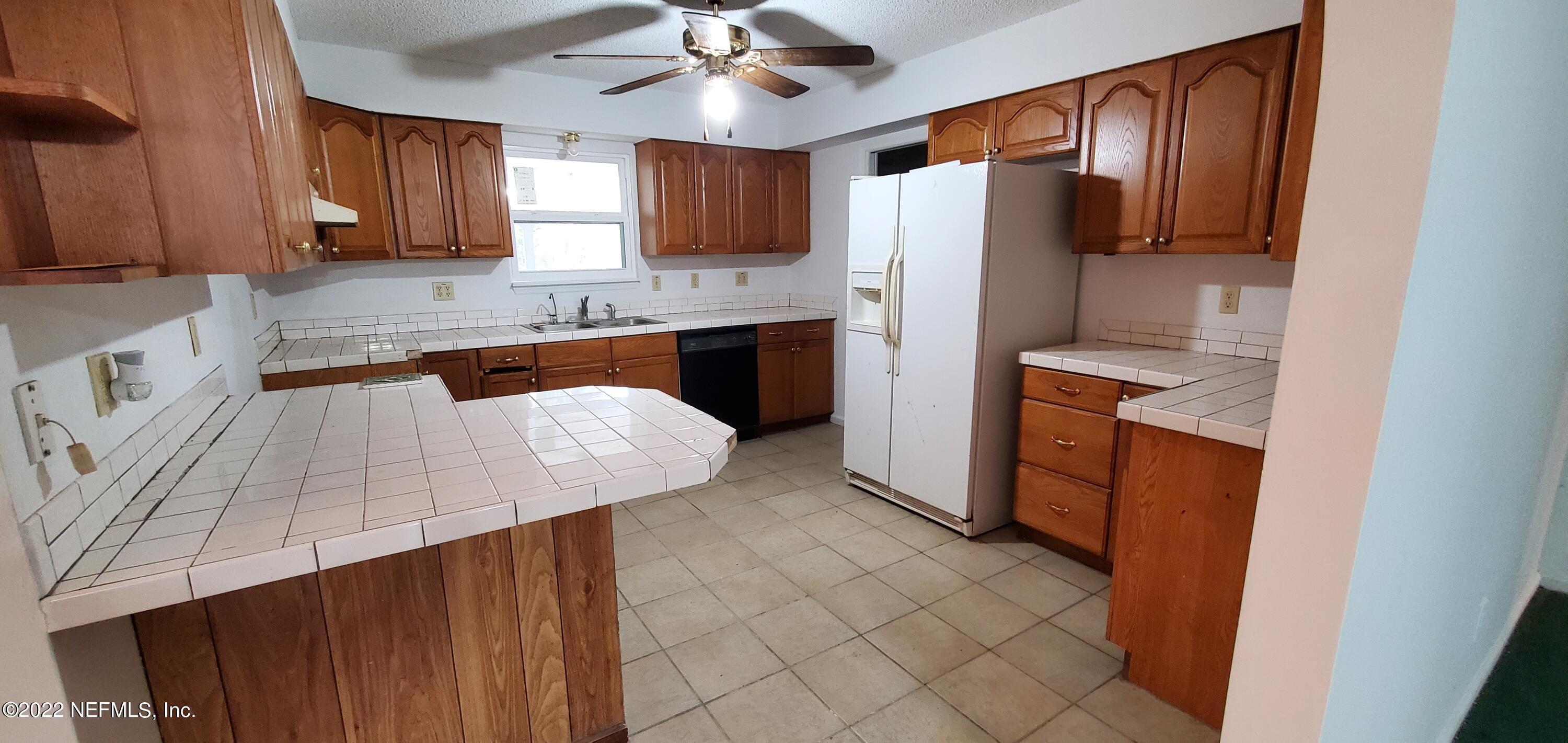 3578 Hamp Hicks Road Bryceville, FL 32009 - Photo 4 of 16 a kitchen with stainless steel appliances a refrigerator a sink a stove a microwave and island