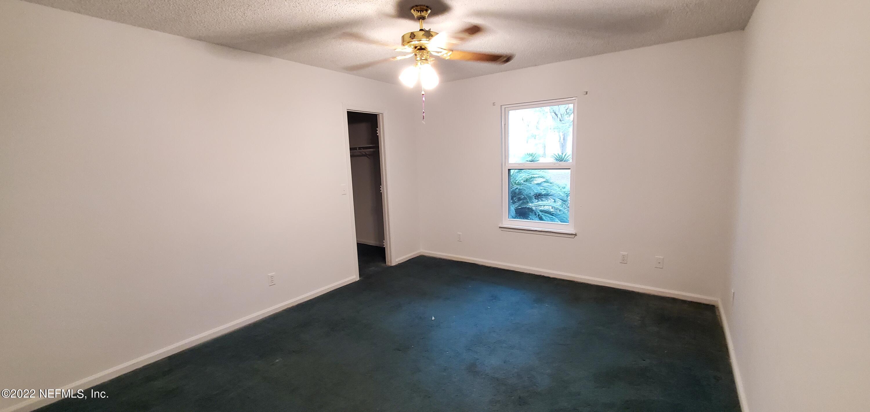 3578 Hamp Hicks Road Bryceville, FL 32009 - Photo 9 of 16 an empty room with windows and fan