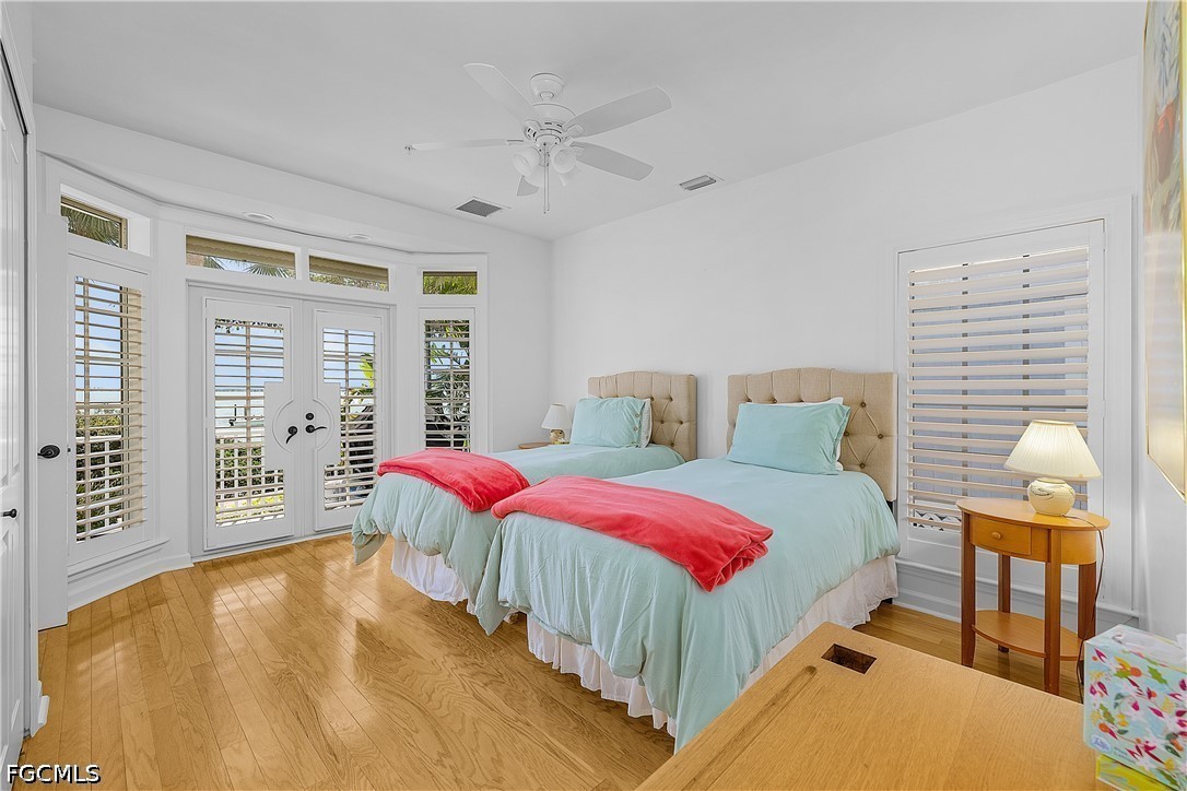 128 Useppa Island Useppa Island, FL 33922 - Photo 23 of 50 a bedroom with two beds and next to a window