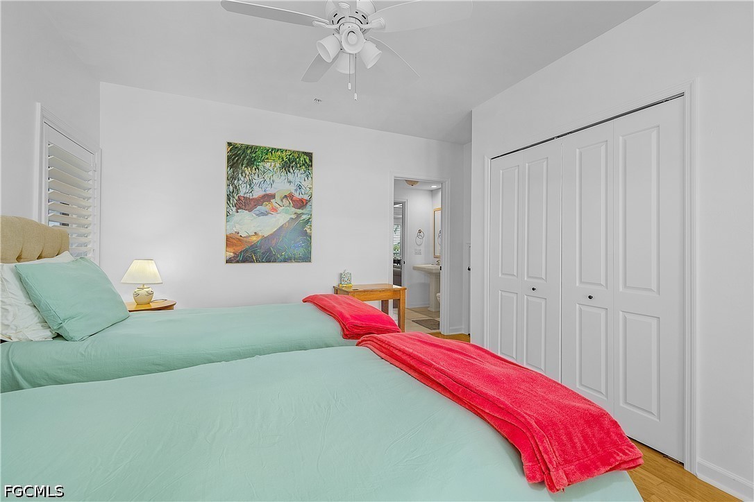 128 Useppa Island Useppa Island, FL 33922 - Photo 24 of 50 a bedroom with a bed and a chandelier
