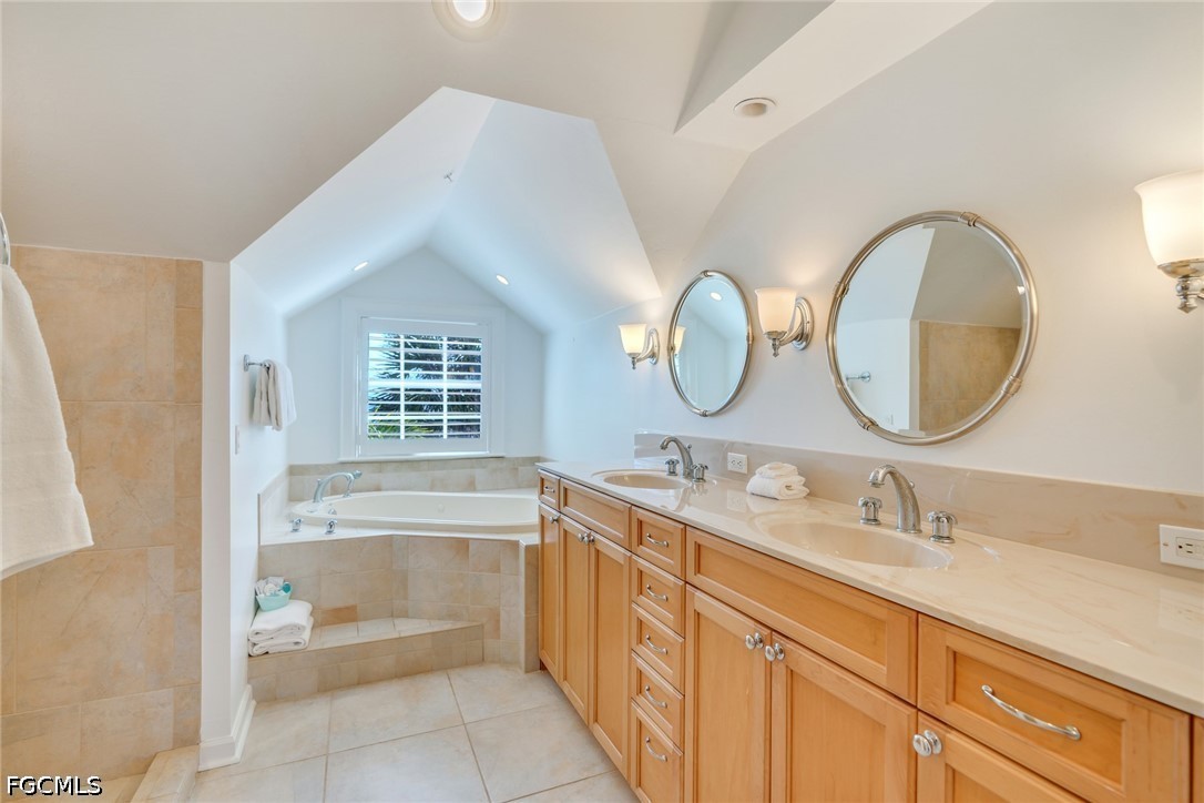 128 Useppa Island Useppa Island, FL 33922 - Photo 39 of 50 a bathroom with a granite countertop sink mirror and bathtub