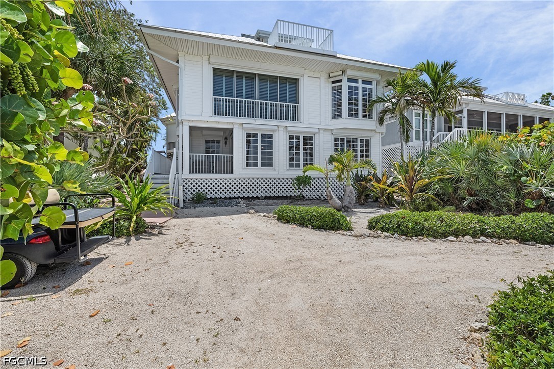 128 Useppa Island Useppa Island, FL 33922 - Photo 40 of 50 a front view of a house with a yard and a garden