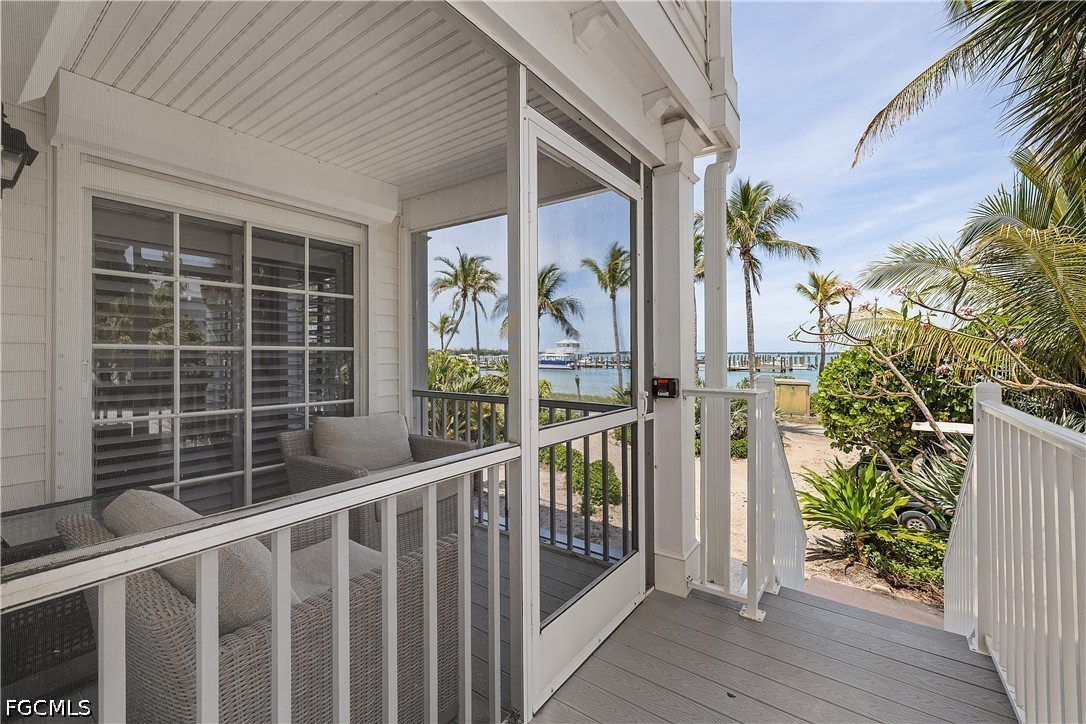 128 Useppa Island Useppa Island, FL 33922 - Photo 41 of 50 a view of porch with wooden floor and chair