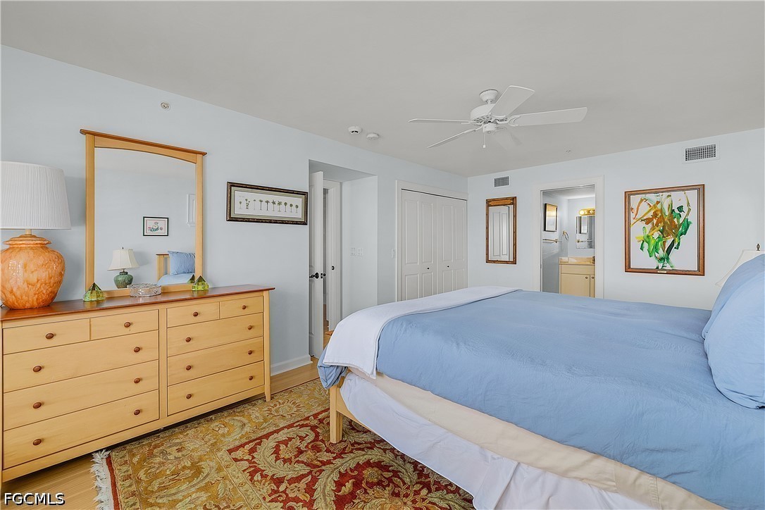 128 Useppa Island Useppa Island, FL 33922 - Photo 48 of 50 a bedroom with a bed and wooden floor