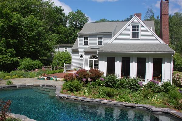 394 Lowell Road Groton, MA 01450 - Photo 1 of 29 a view of a white house next to a yard