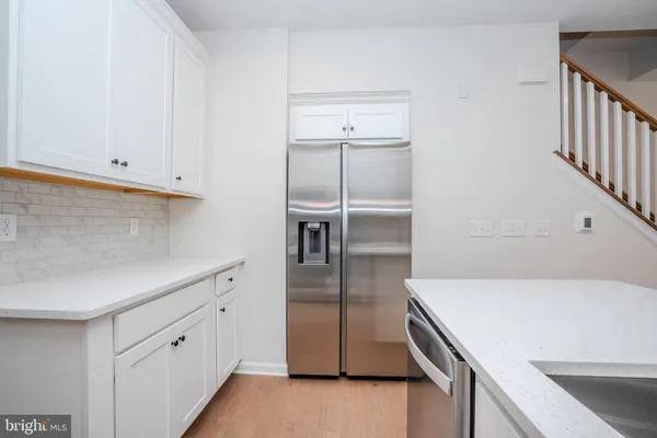 a kitchen with a refrigerator and cabinets