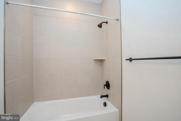 a bathroom with a shower and a bath tub