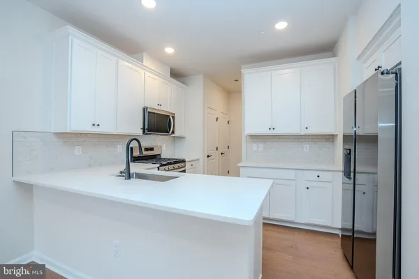 a kitchen with a sink a stove and a refrigerator