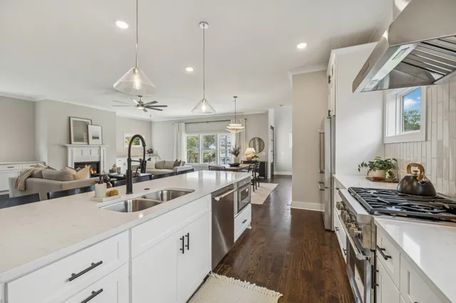 a kitchen with counter top space a sink stainless steel appliances and cabinets
