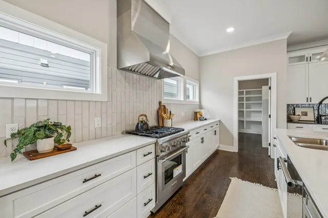 a kitchen with stainless steel appliances white cabinets and a stove