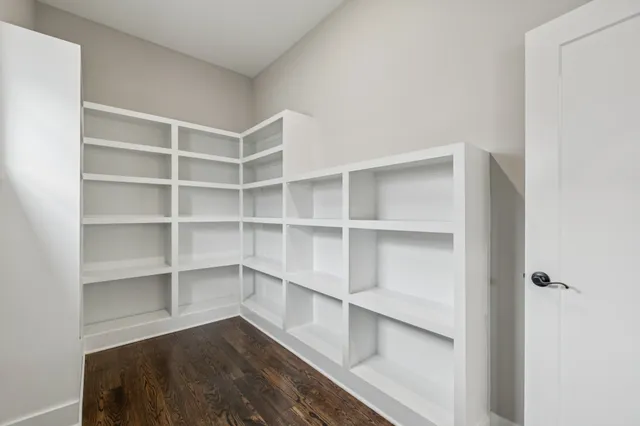 a view of walk in closet with empty racks
