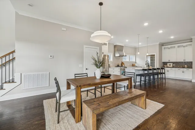 a living room with dining table and a table