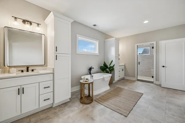 a room with a chandelier furniture and a mirror