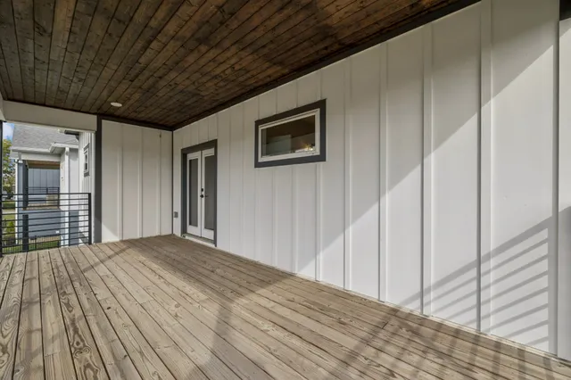 a view of a house with a yard and wooden fence