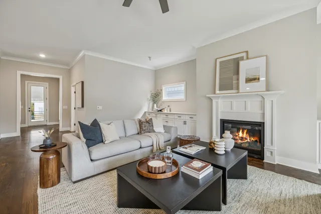 a living room with furniture a fireplace and a table