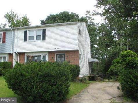 a view of a house with a yard and plants
